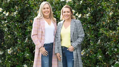 Jackie and Becki standing in front of a hedge