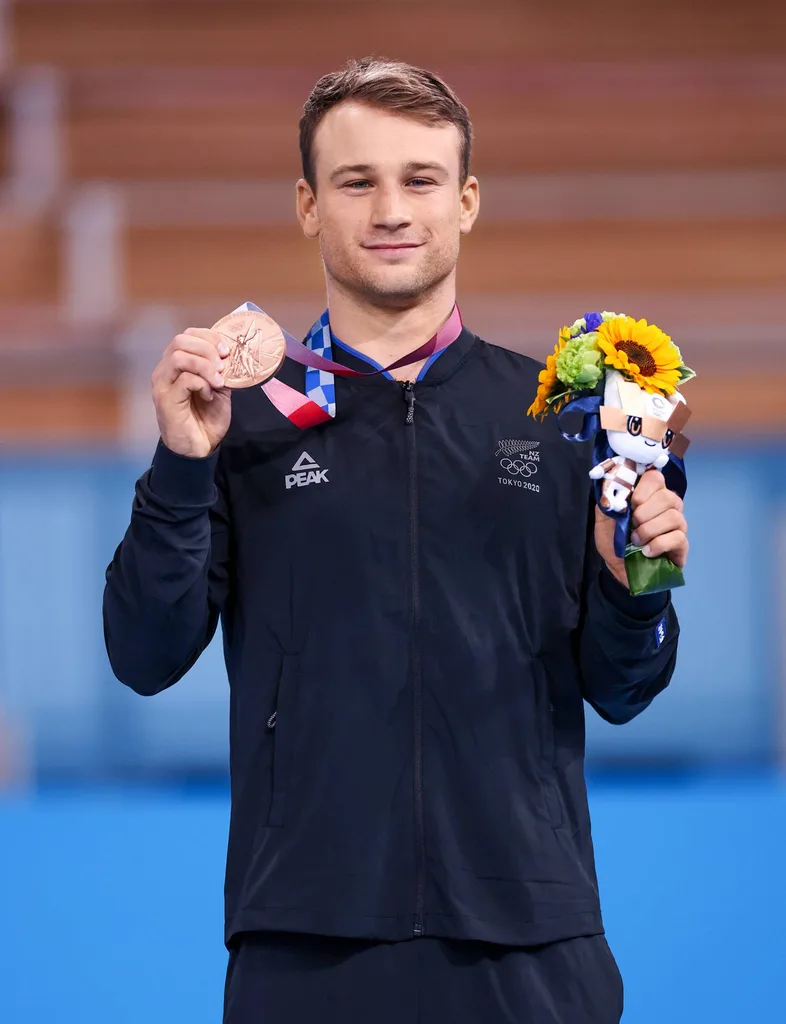 Dylan on the podium with his medal and some flowers