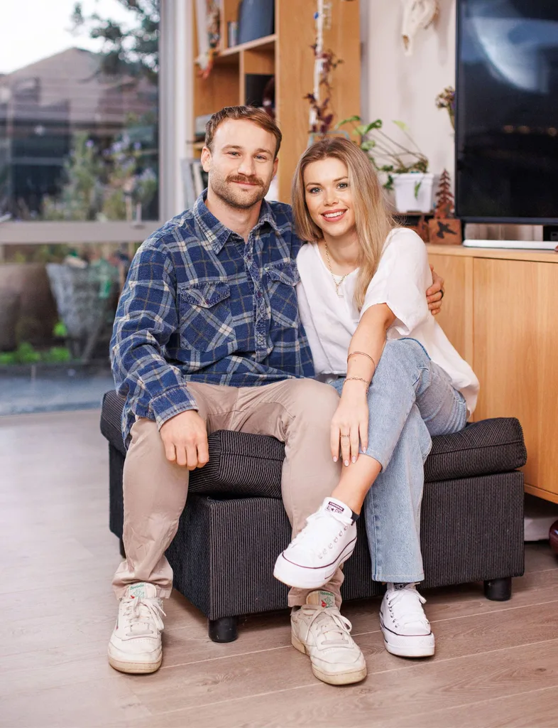 Dylan and Maddie sitting together on an ottoman