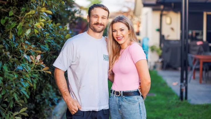 Dylan Schmidt and Maddie Davidson in front of a hedge