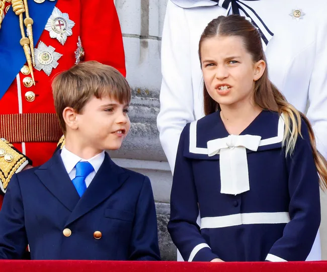 Prince Louie pulling funny faces at Princess Charlotte on the balcony