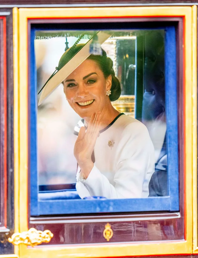 Princess Katewaving to the poublic through a carriage window