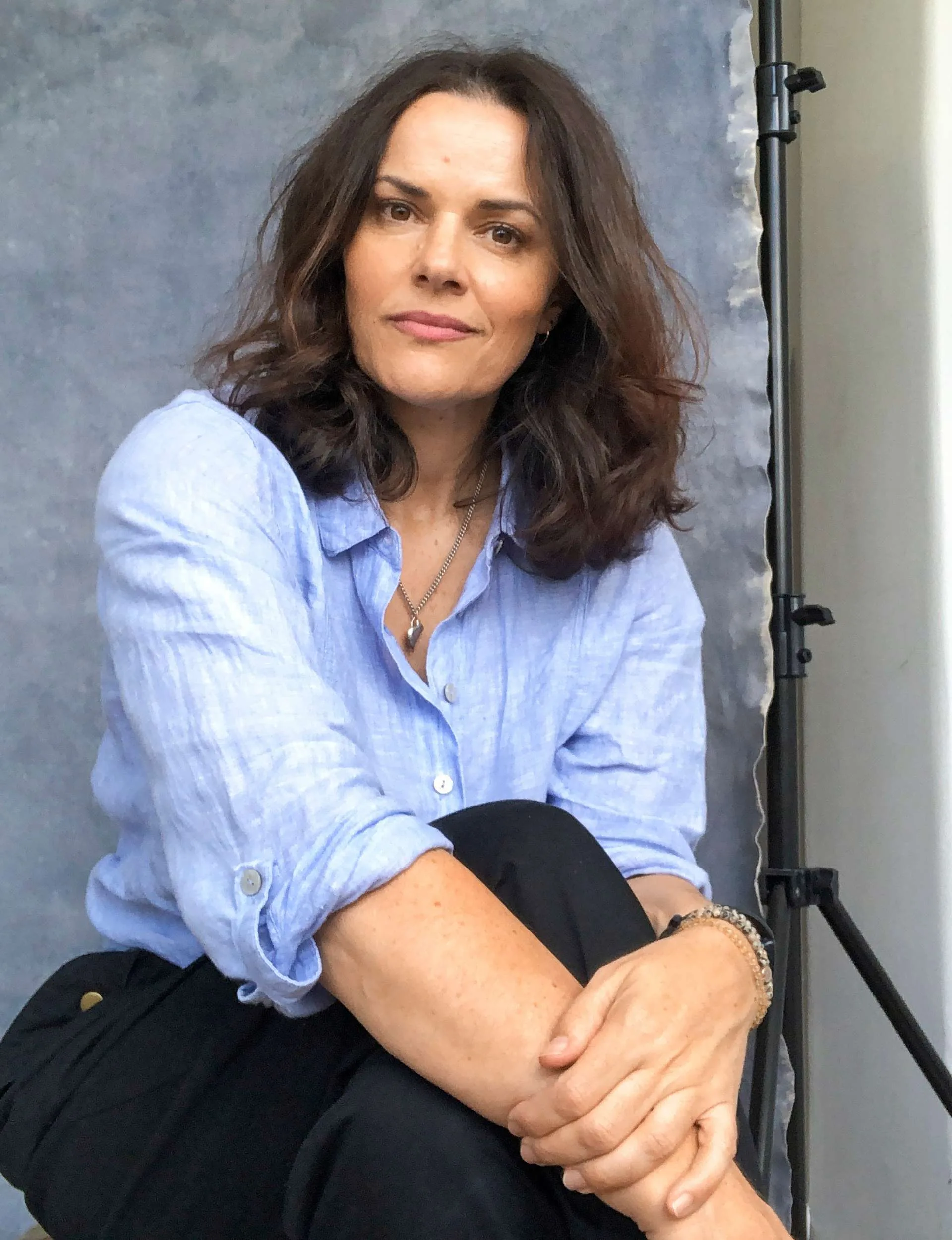 Amanda Billing sitting in front of a grey backdrop