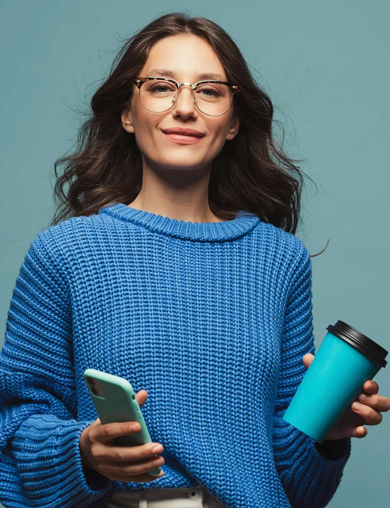 Woman doing Dry July holding a coffee carry cup and her phone