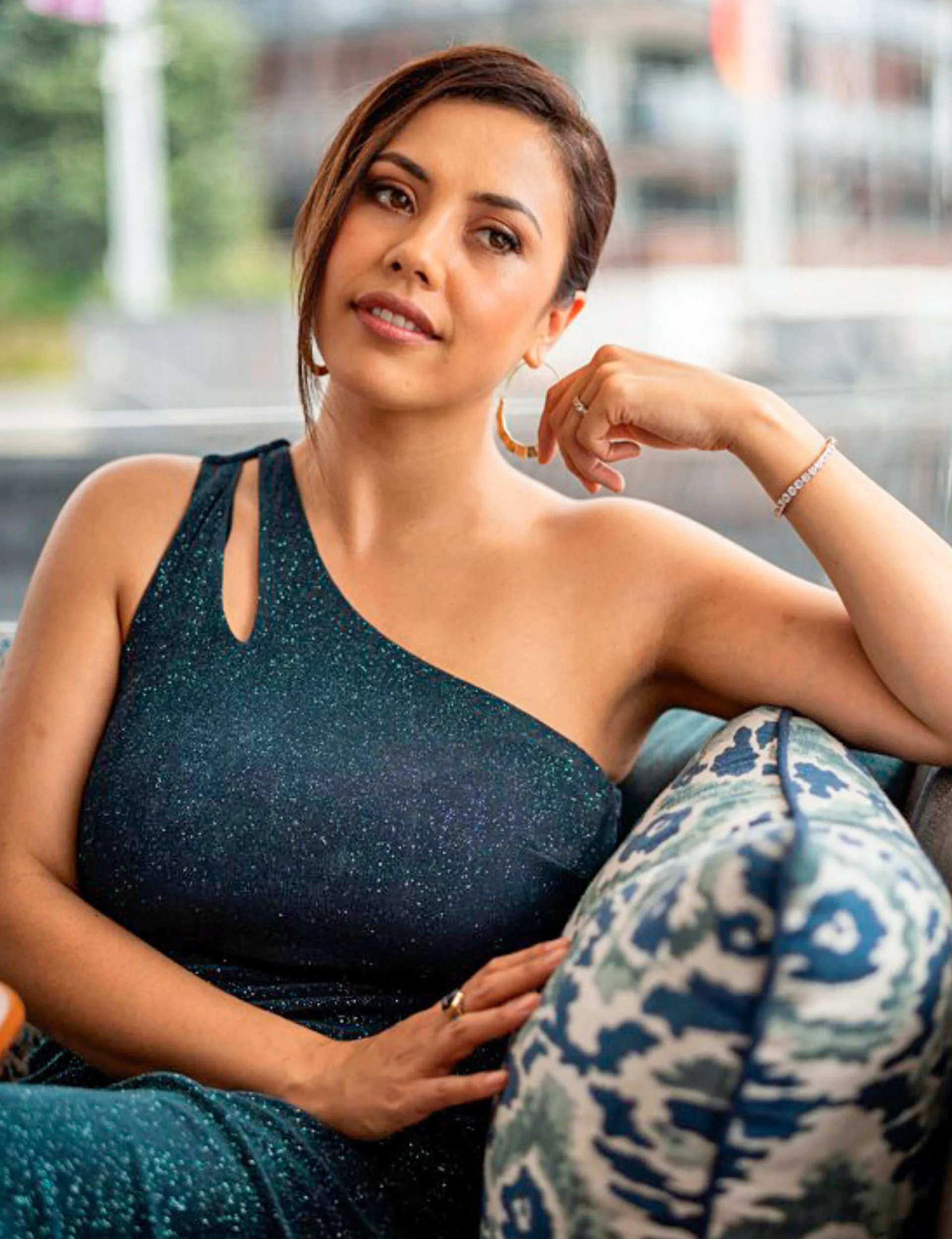 Ngahuia Piripi leaning on the back of a couch