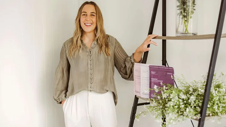 Emma Michelson standing beside a shelf of her morning sickness remedy