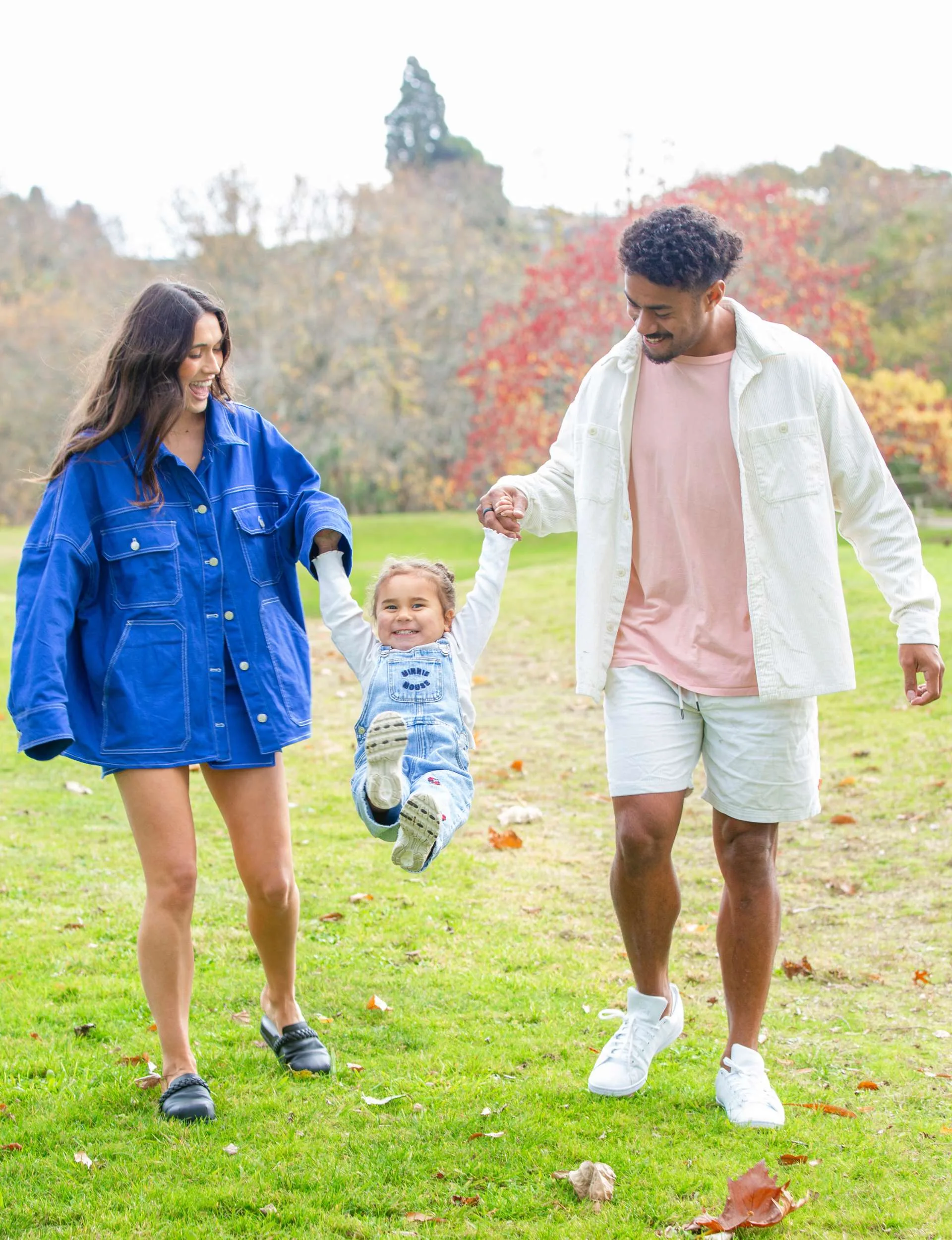 Emoni and Danielle swinging Milla between them