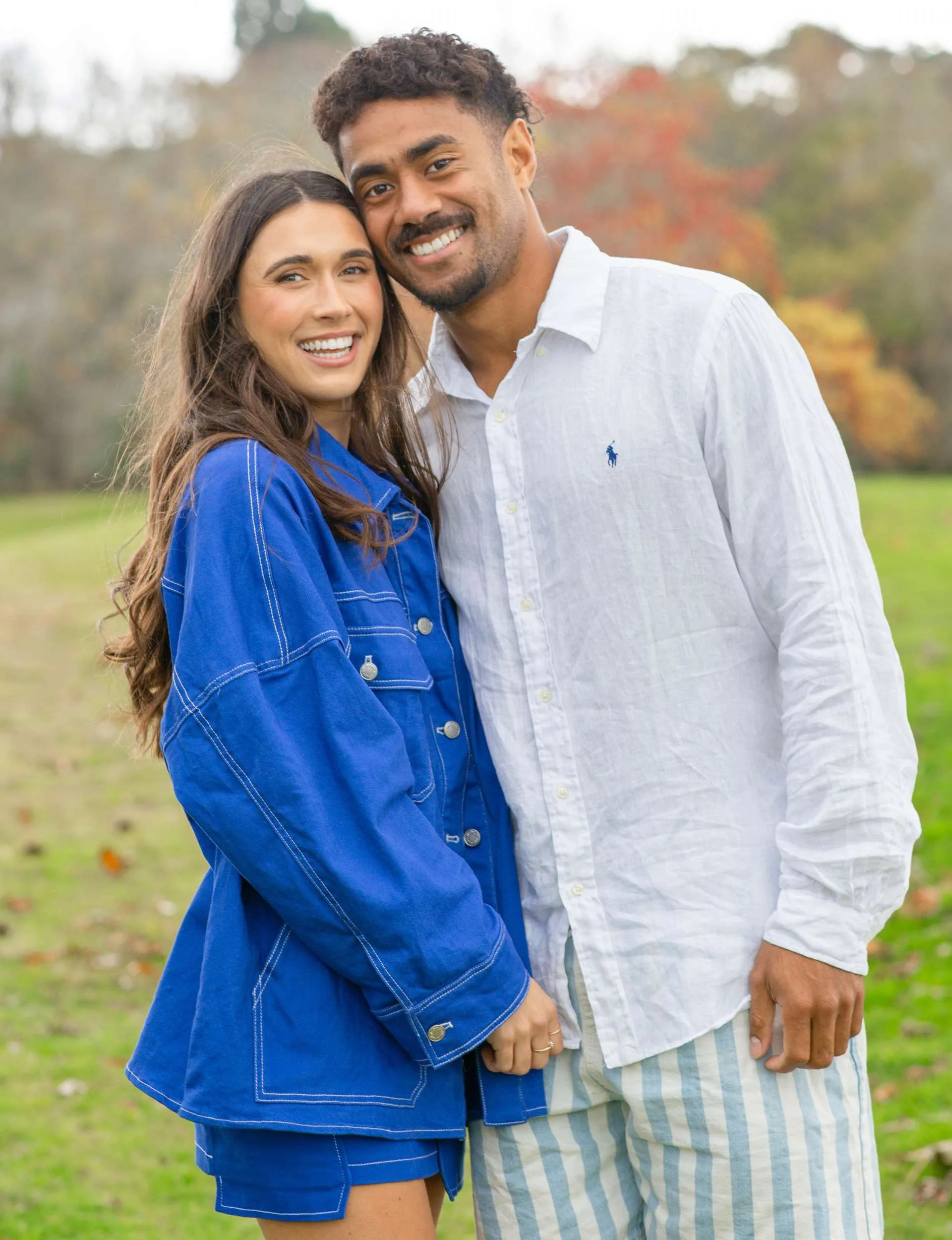 Emoni Narawa and partner Danielle standing on a field