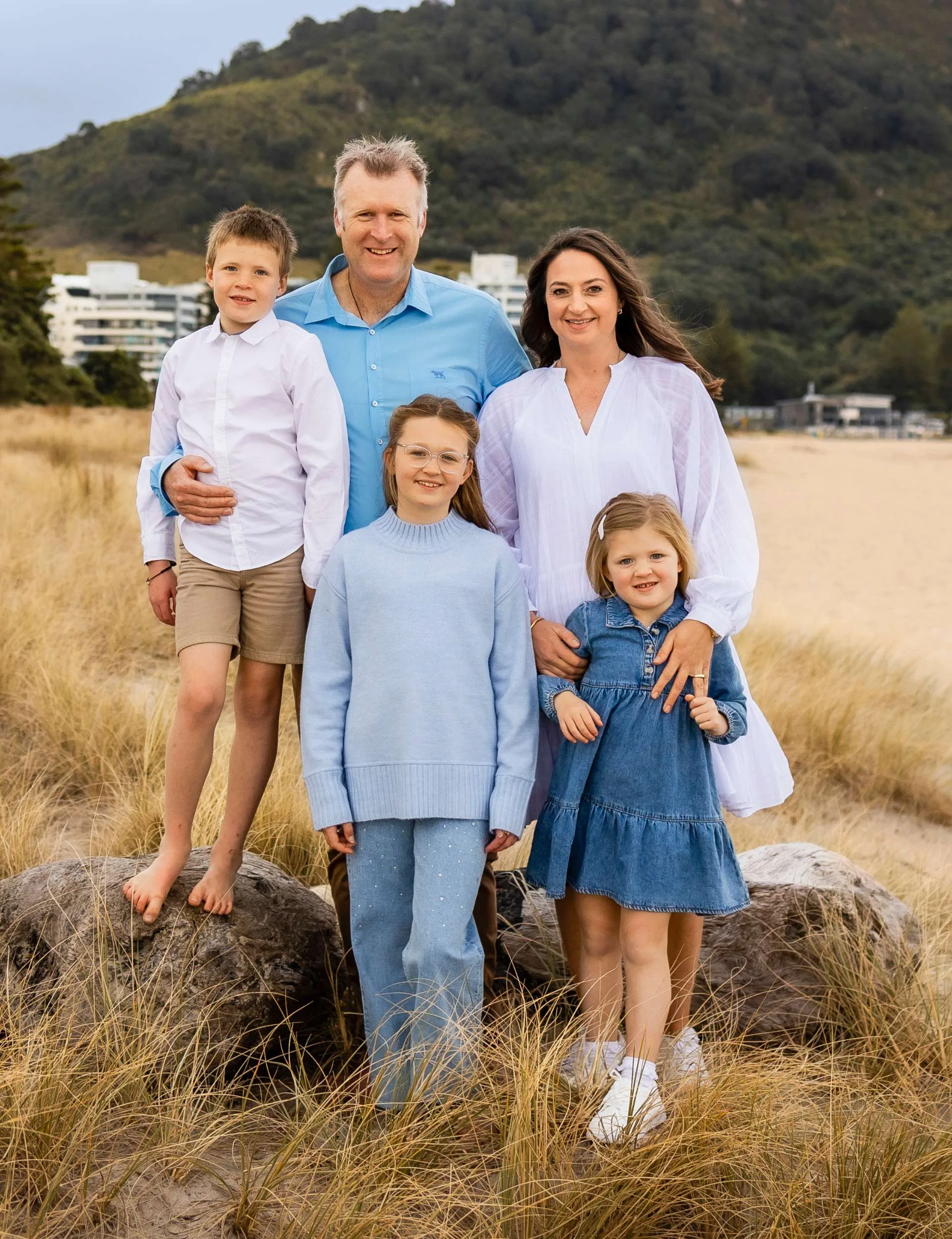 The Drysdale family standing together in tall grasses