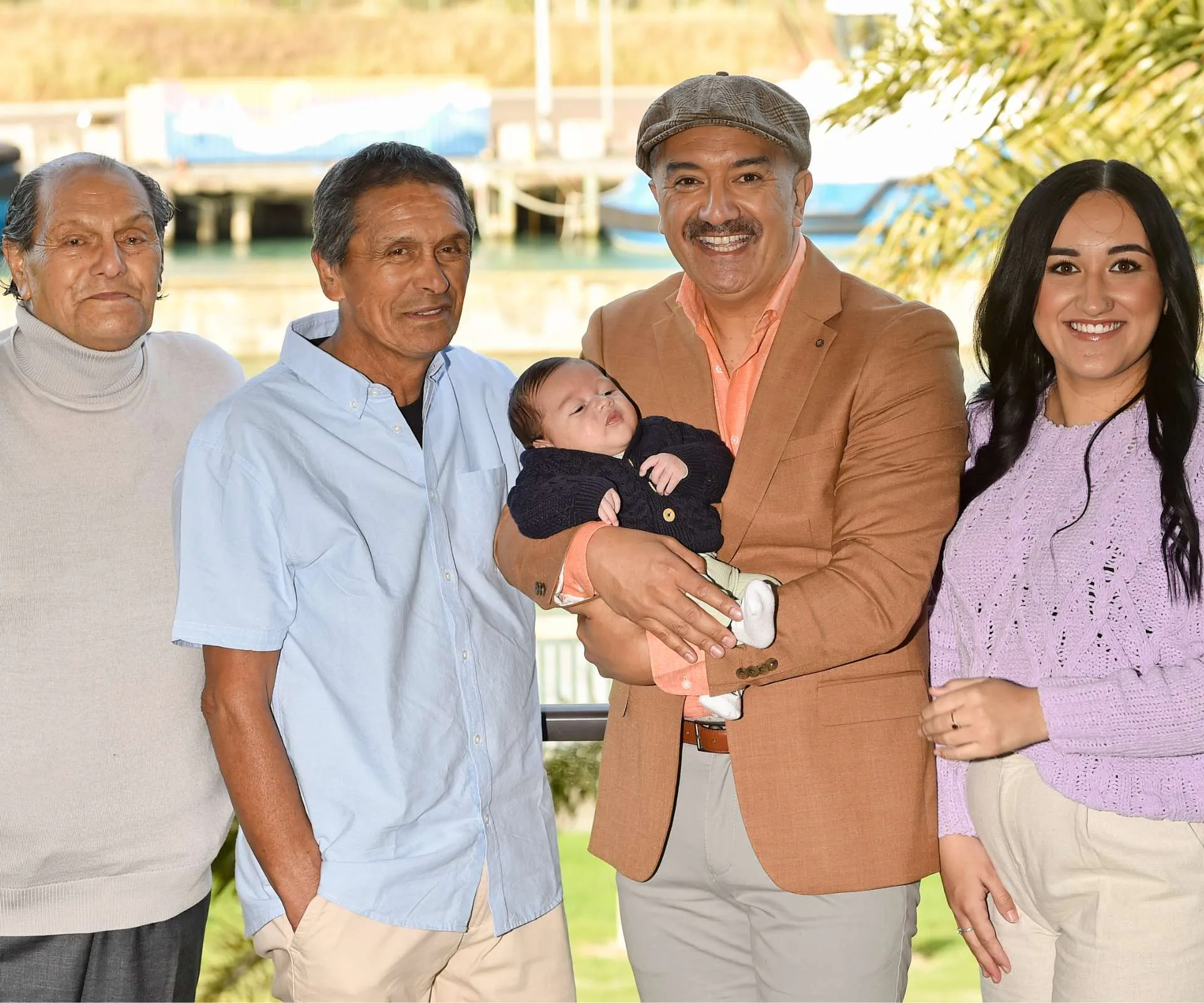 Mātai Smith holding baby Raekahu, with Mātai’s grandfather Mātai, dad Whenu and niece Samara around him