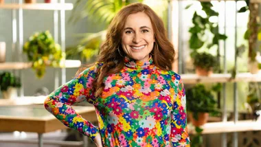 Rhiannon McCall smiling with one hand on her hip