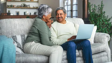Shot of a senior couple using a laptop on the sofa at home
