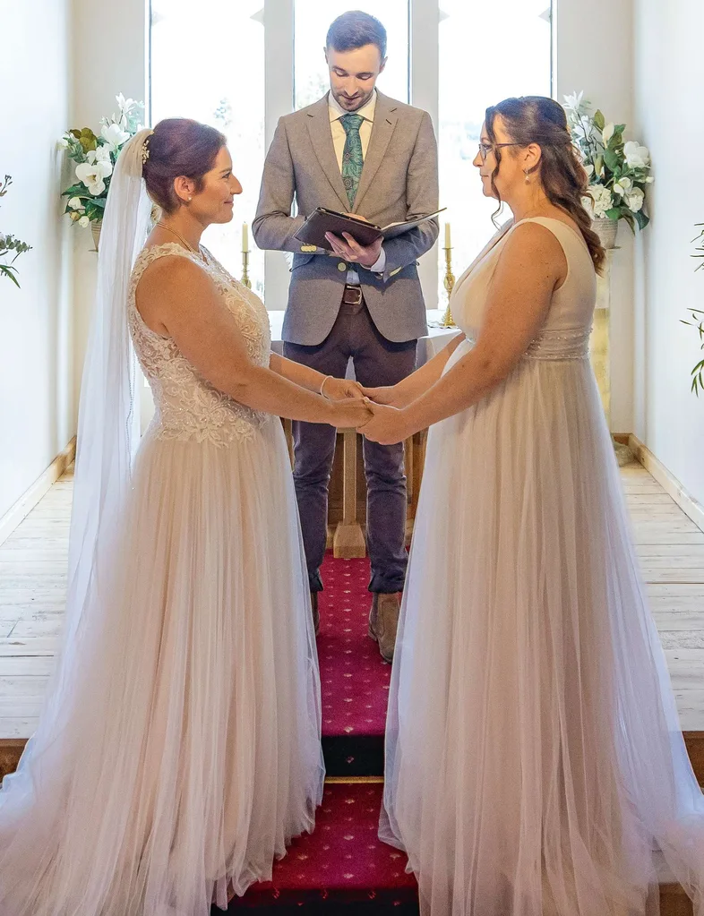 Holding hands at the altar as the celebrant speaks