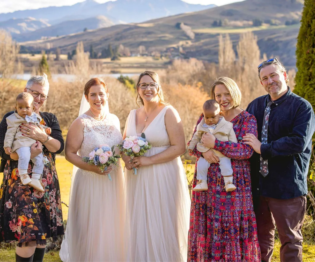 Melanie and Leah with the sons' godparents on either side of them on their wedding day