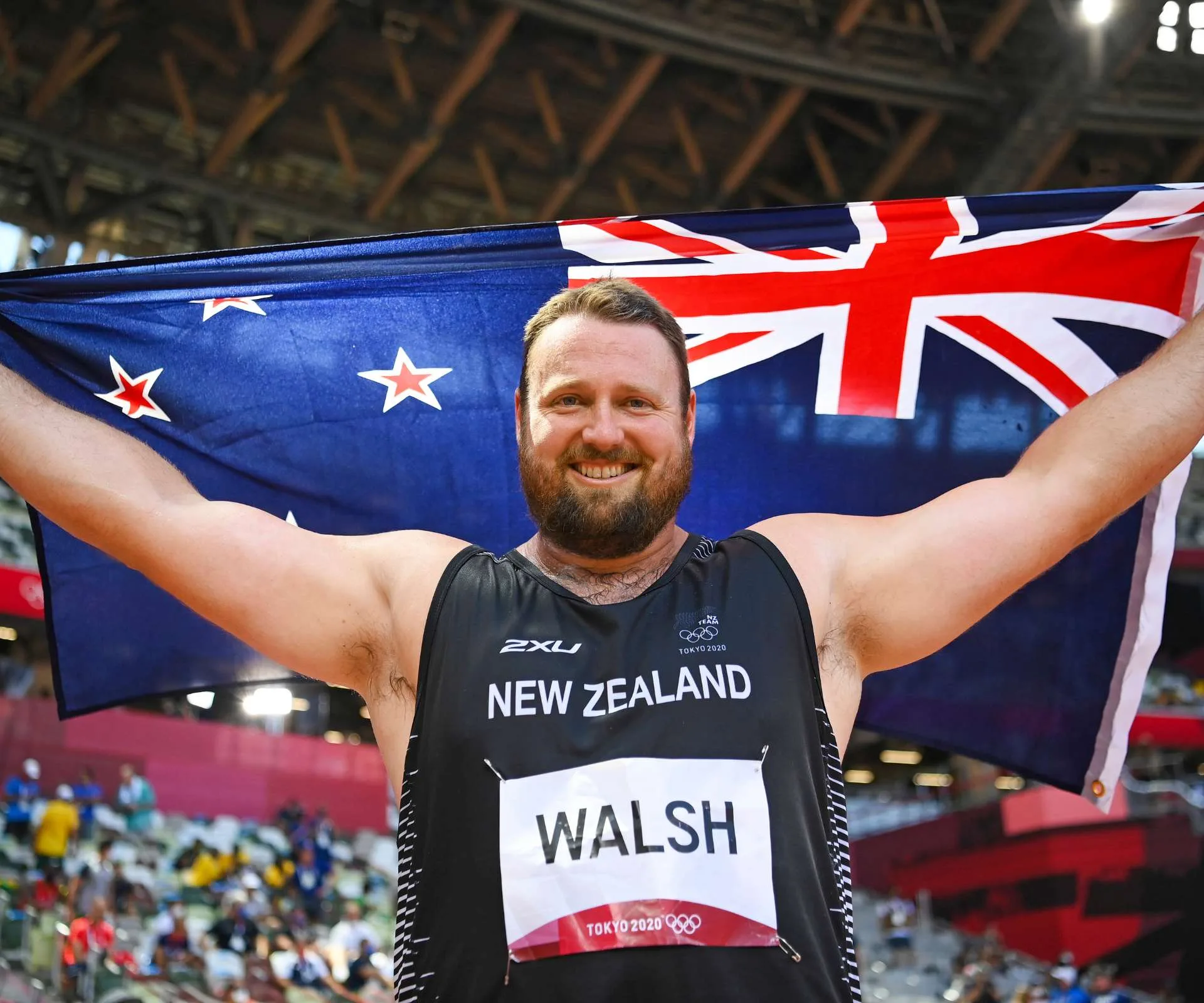 Tom flying the New Zealand flag after his commonwealth games win