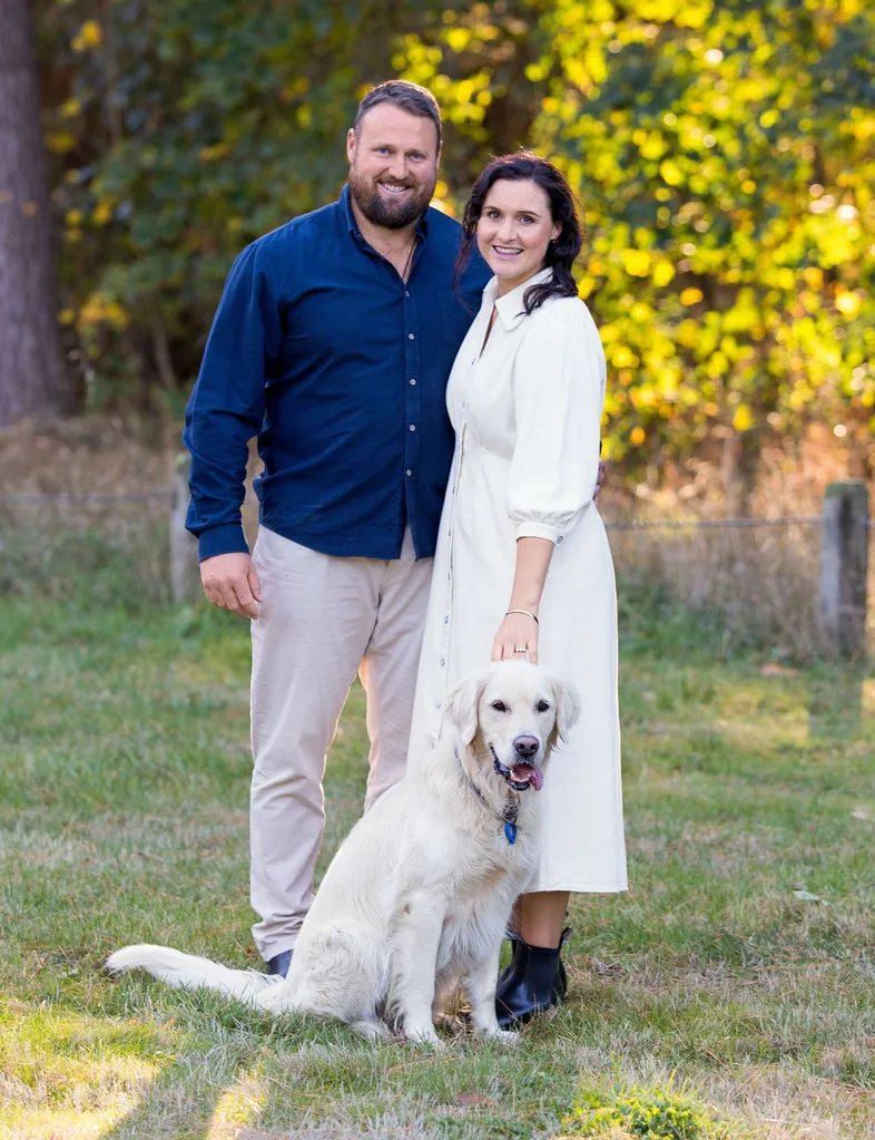 Tom, Dana and golden retriever Rippa in a field