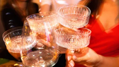 Blurry wine glasses cheersing