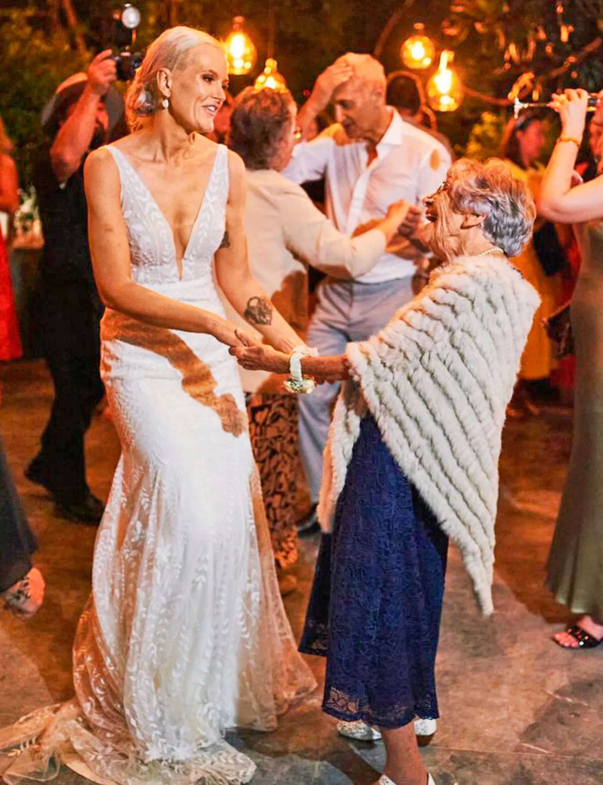 Heidi holding May's hands and dancing at her wedding