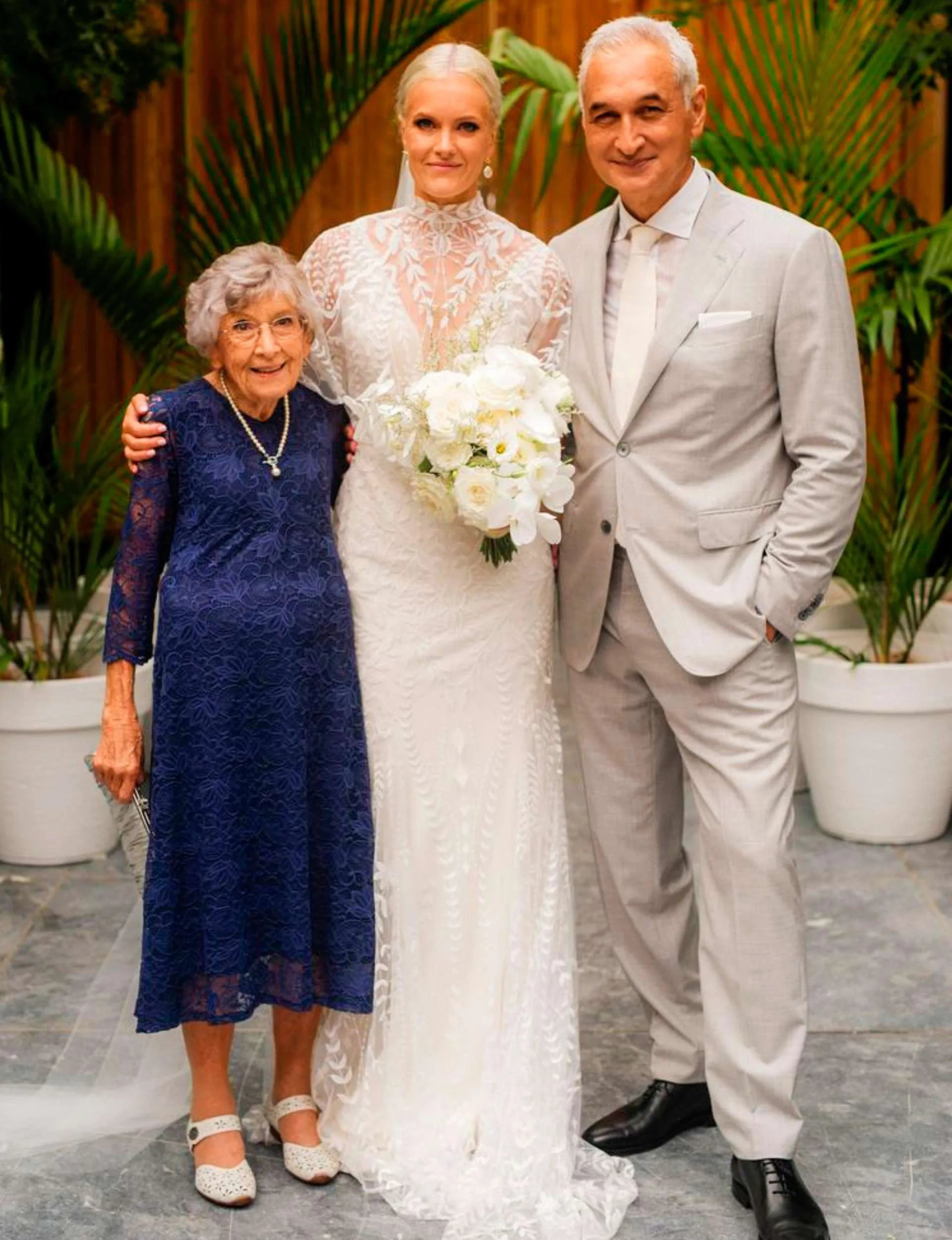 Mike, Heidi and May standing together in the couple's wedding day