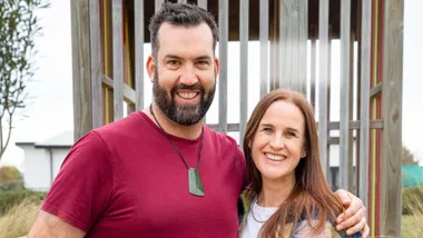 Jay and wife Nicky standing together in front of a playground