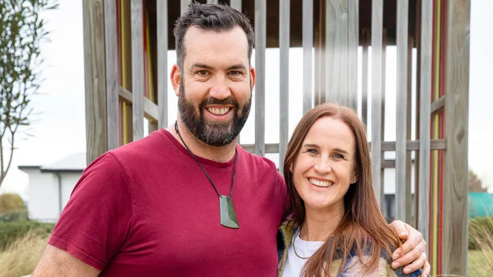 Jay and wife Nicky standing together in front of a playground