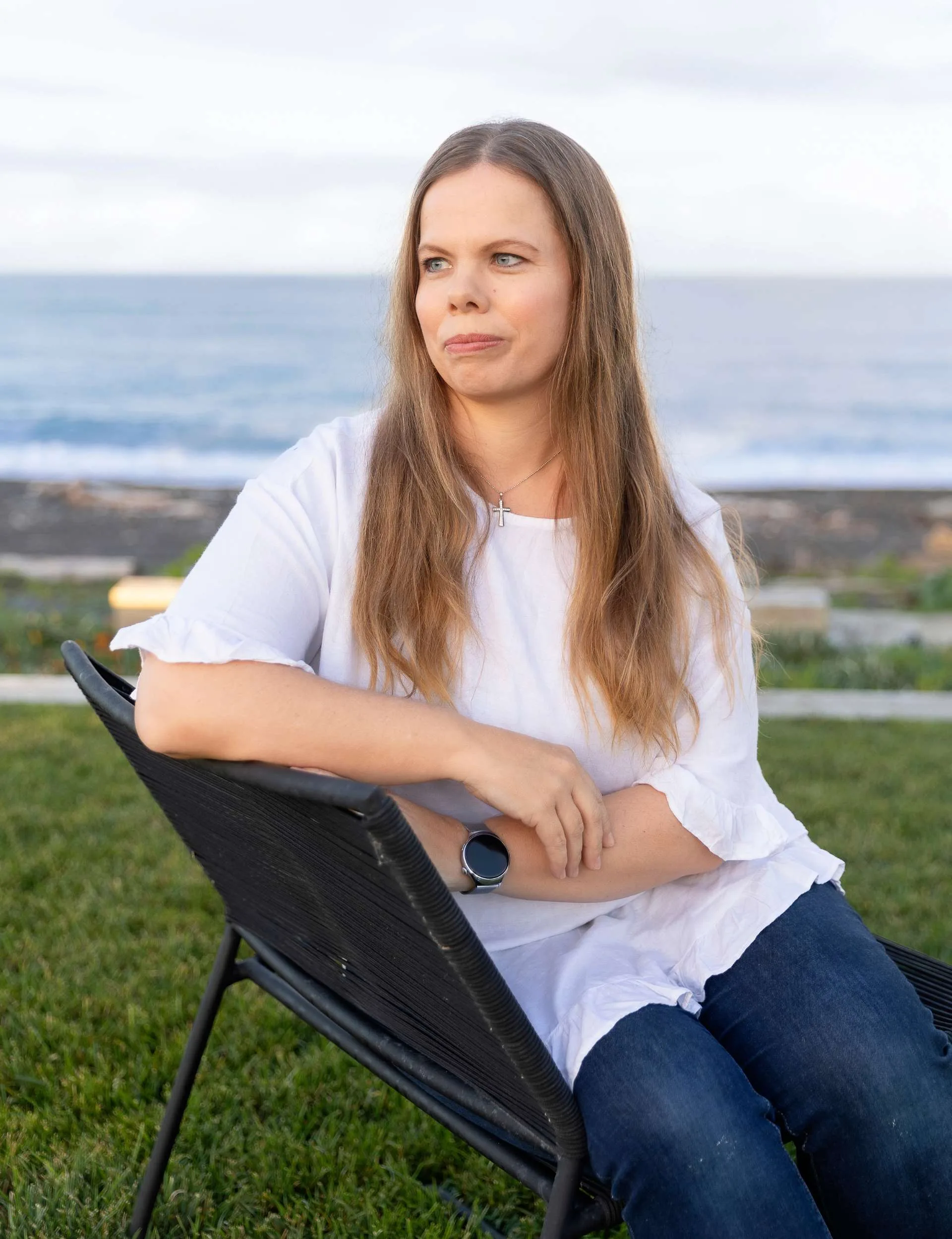 Joanne sitting on a chair by herself, looking to the left