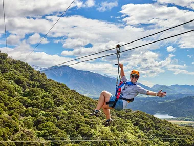 A person ziplining over the town of Kaikōura