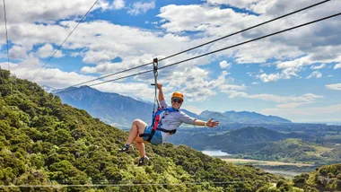 A person ziplining over the town of Kaikōura