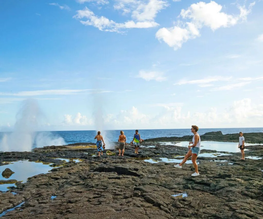 People exploring the Alofaaga Blowholes