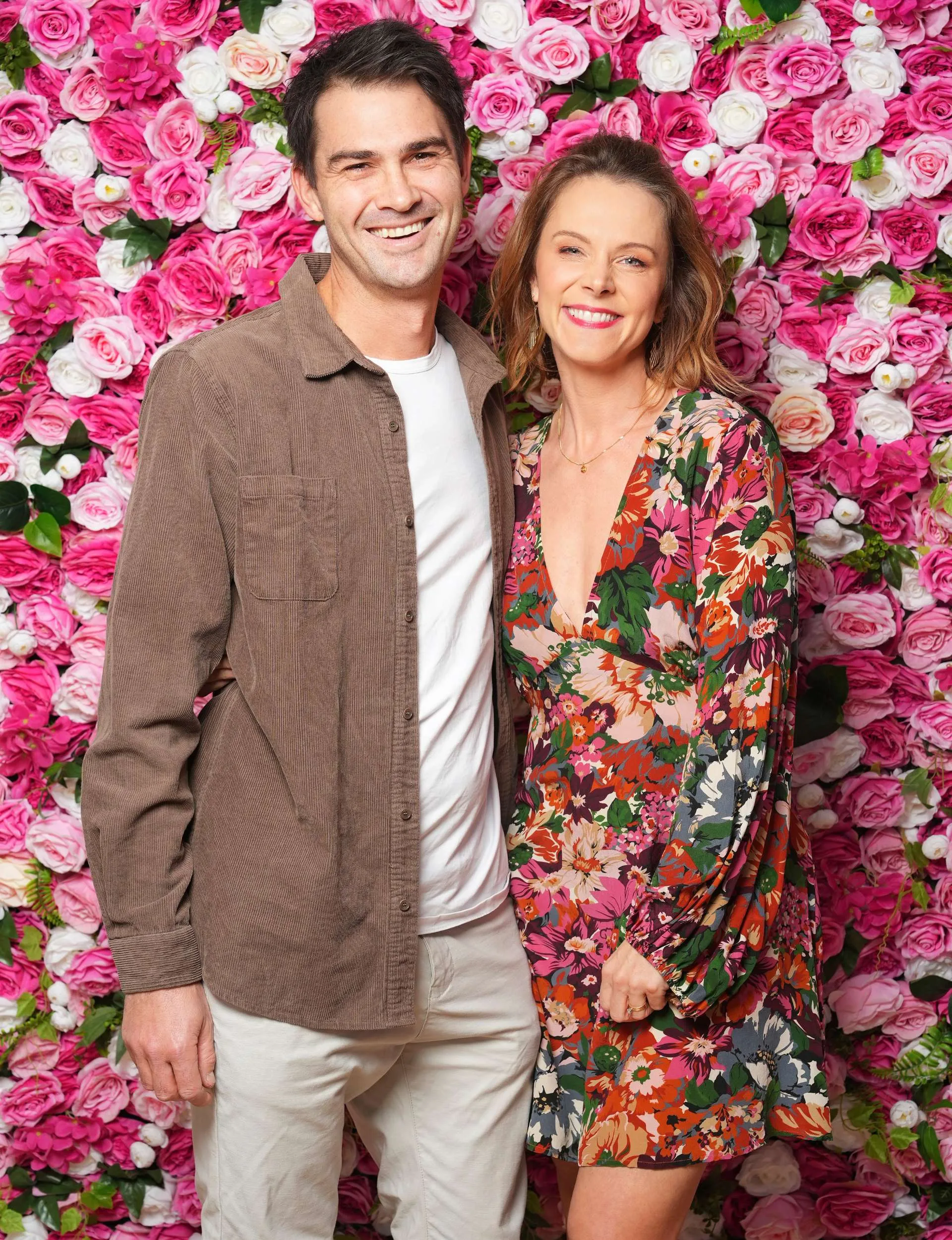With husband Chris in front of a flowery photo wall