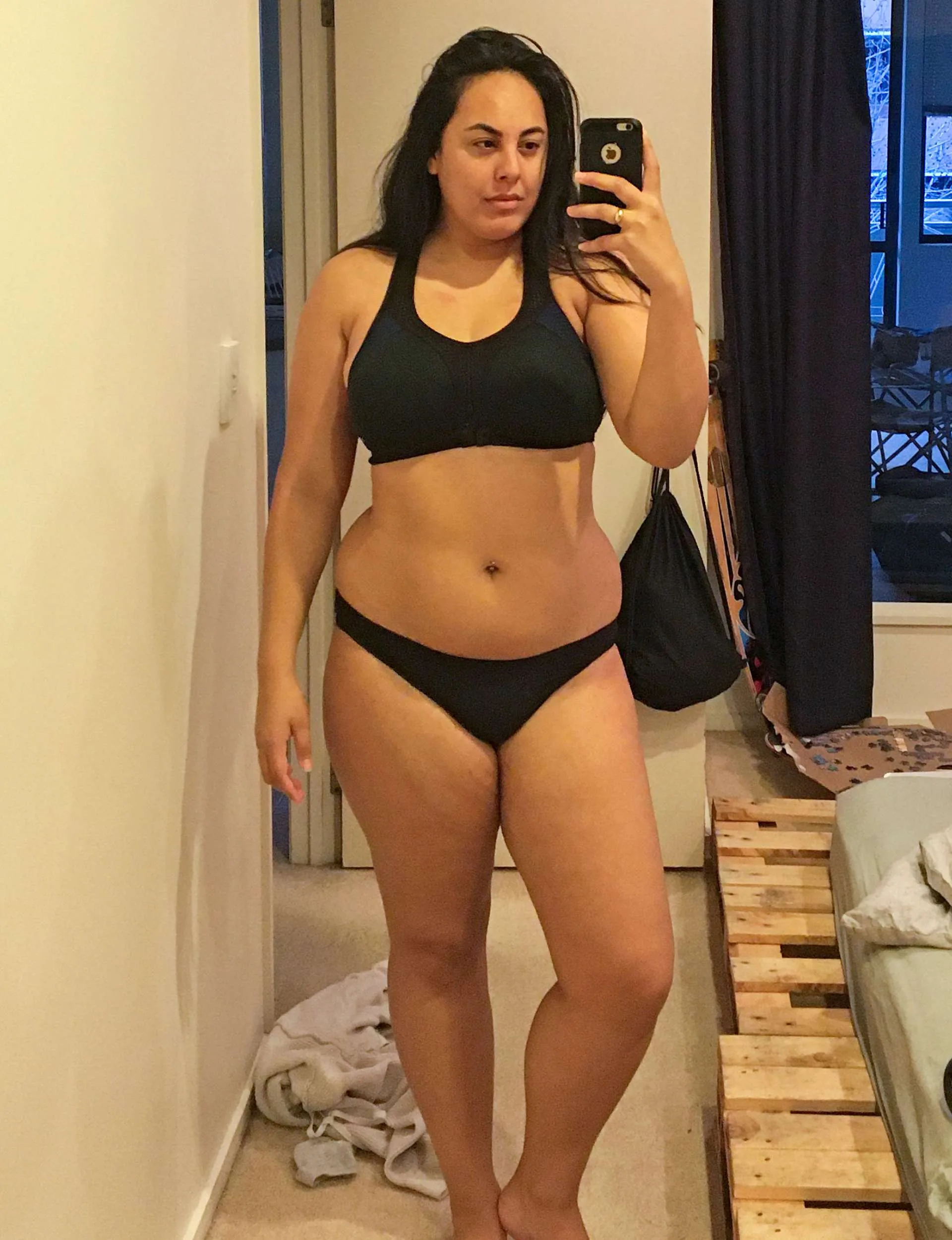 A mirror selfie of Rusha in black underwear before her weight loss journey