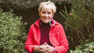 Helen Brown sitting on stones in a garden