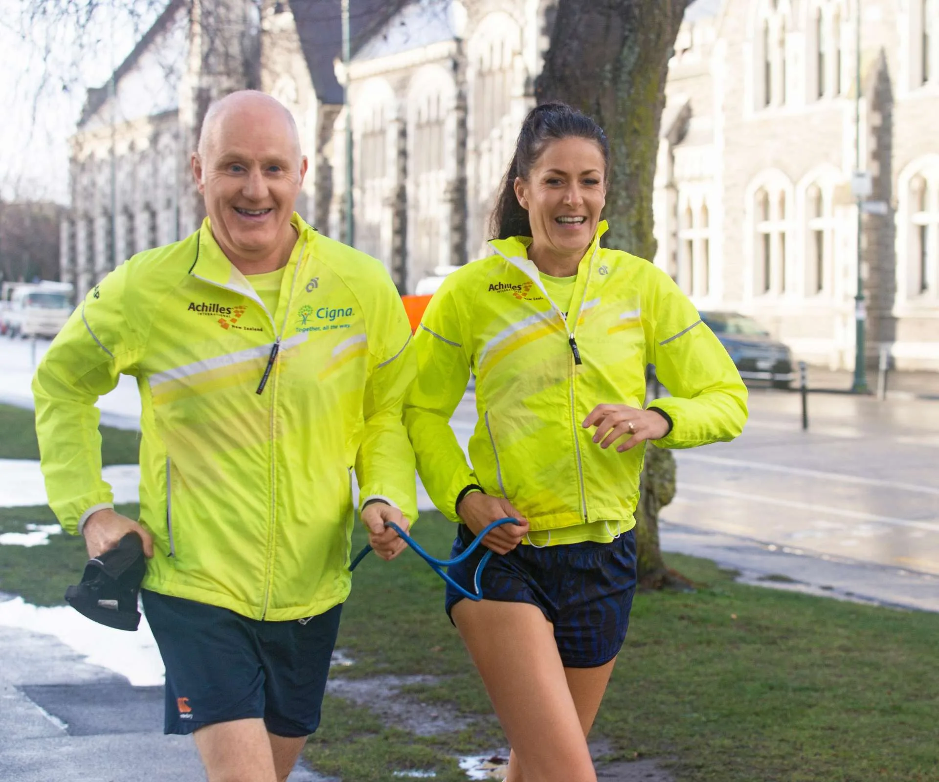 Rosie and Paul running together in matching high-vis jackets