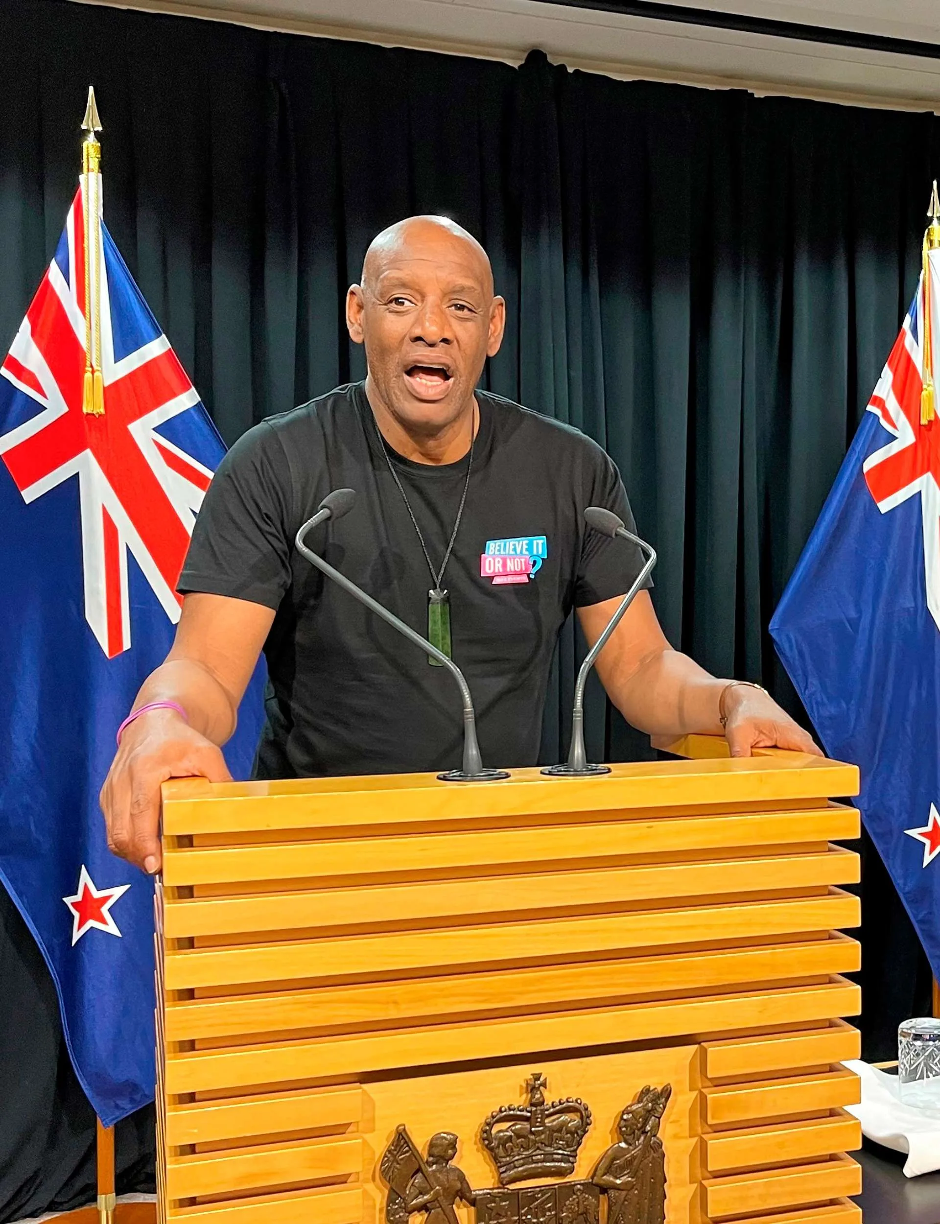 Shaun standing at the speech booth in Parliament