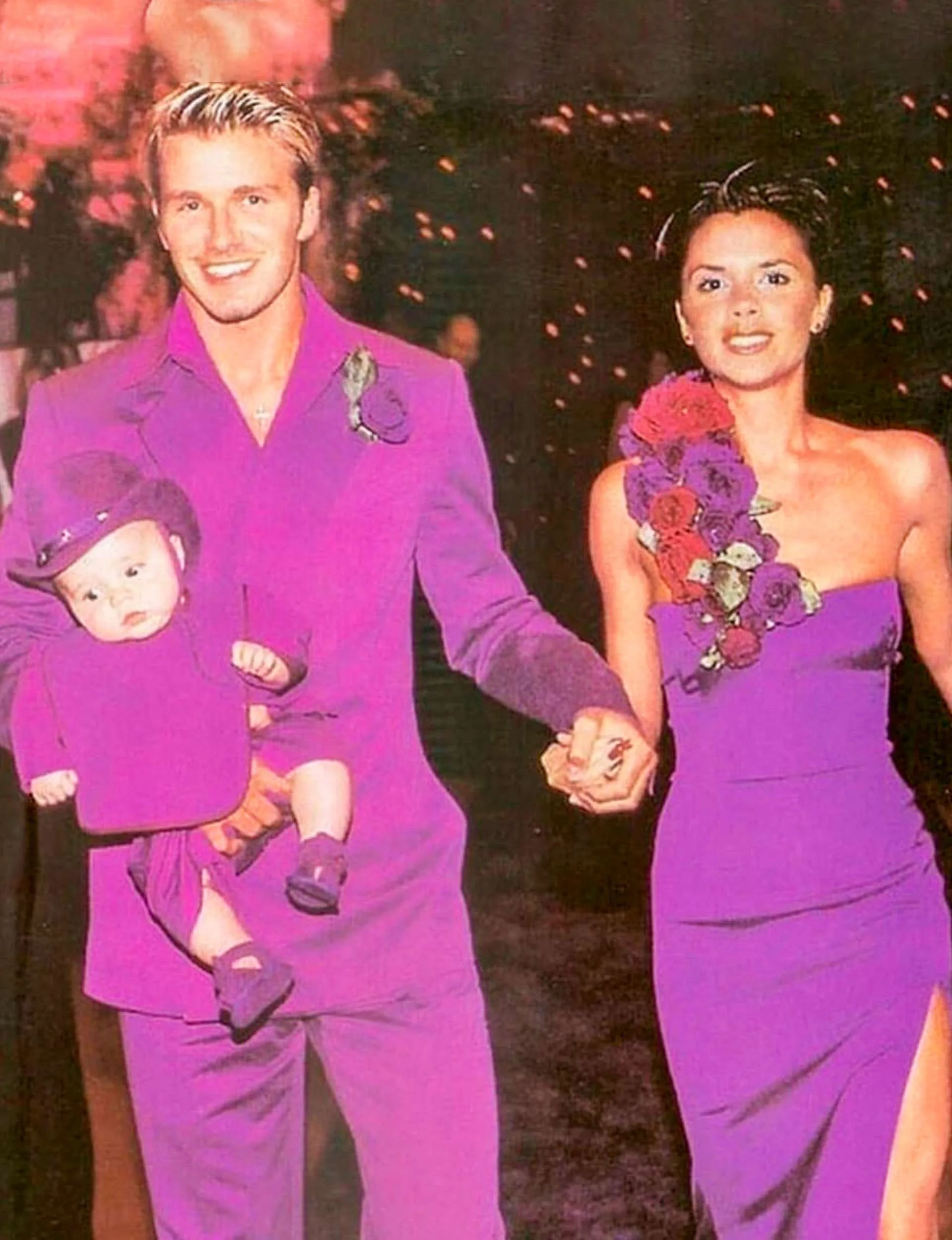 In their infamous purple wedding outfits with baby Brooklyn on their wedding day