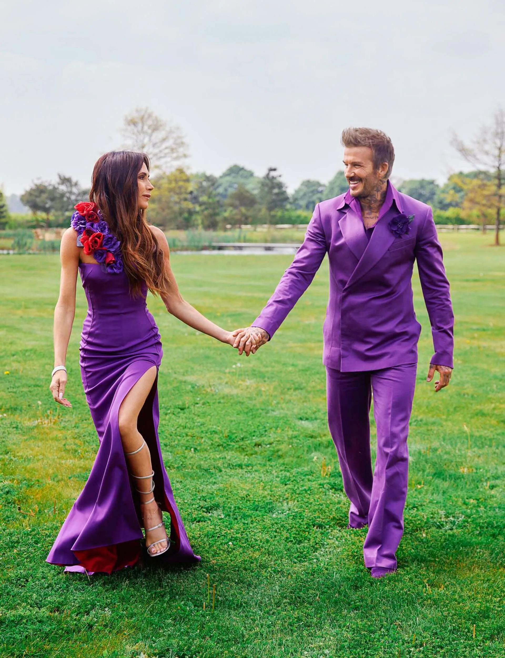 In their infamous purple wedding outfits walking through a field to honour their 25 year wedding anniversary