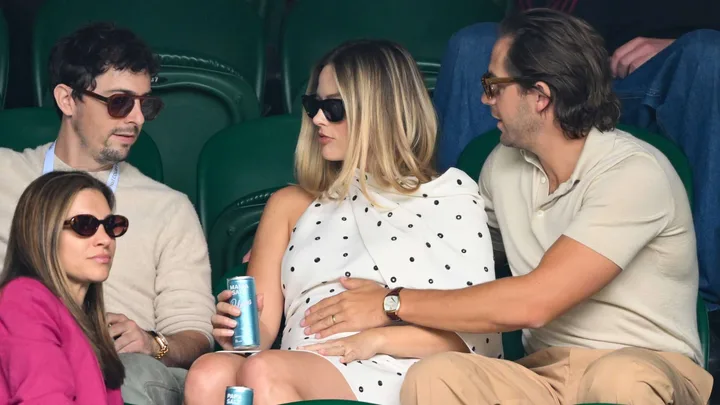 Margot Robbie and husband Tom holding her pregnant belly at Wimbledon