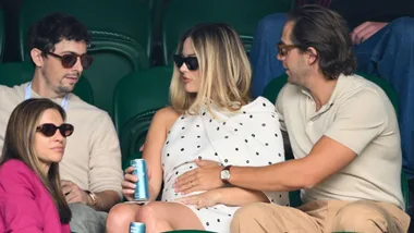 Margot Robbie and husband Tom holding her pregnant belly at Wimbledon