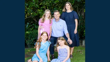 Tim Costley and his family in front of a hedge