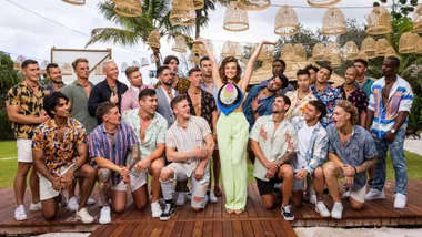 The boys from FBoy Island all looking at one girl in the middle of the group