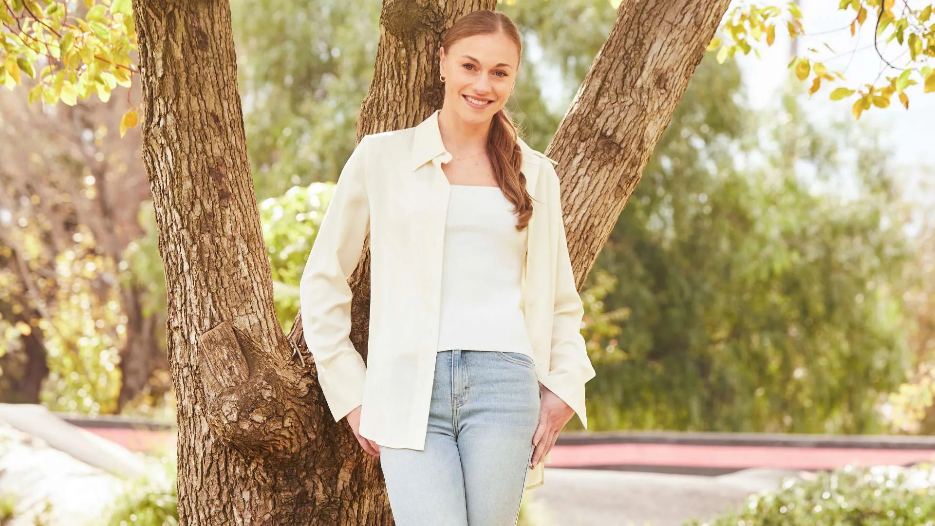 Georgia-Rose standing against a tree