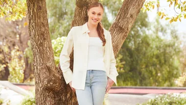 Georgia-Rose standing against a tree