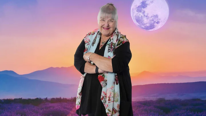 Jackie in front of an image of a sunset with the moon clearly visible in the sky