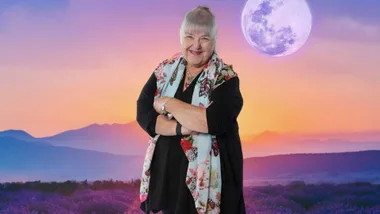Jackie in front of an image of a sunset with the moon clearly visible in the sky