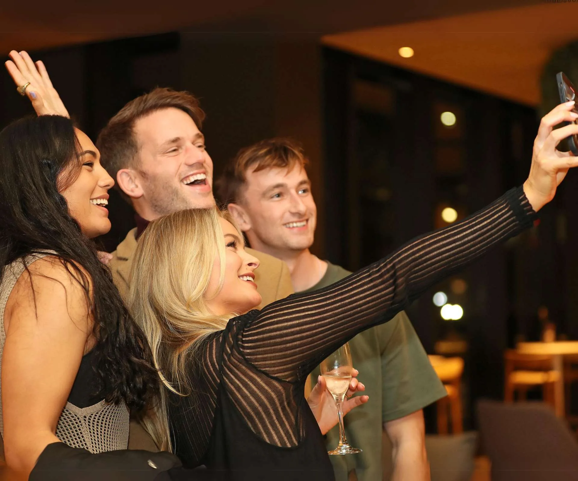 Brittany taking a selfie with a few of her Traitors co-stars