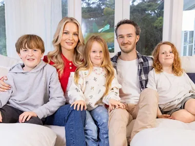 Traitors star Brittany and her family on a couch