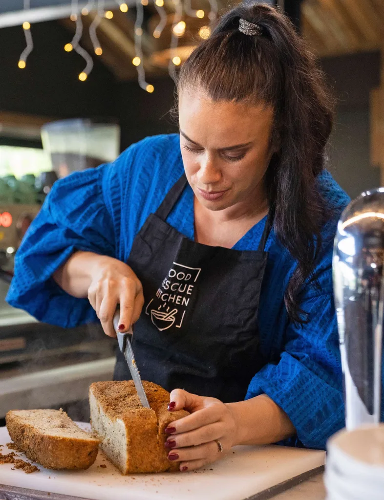 Naomi slicing a loaf