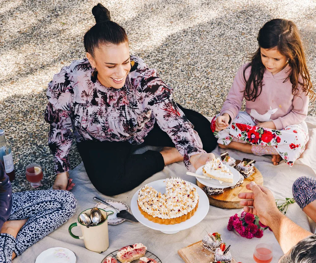 Sharing a plate at a picnic while sitting beside daughter Manawa-Ora.