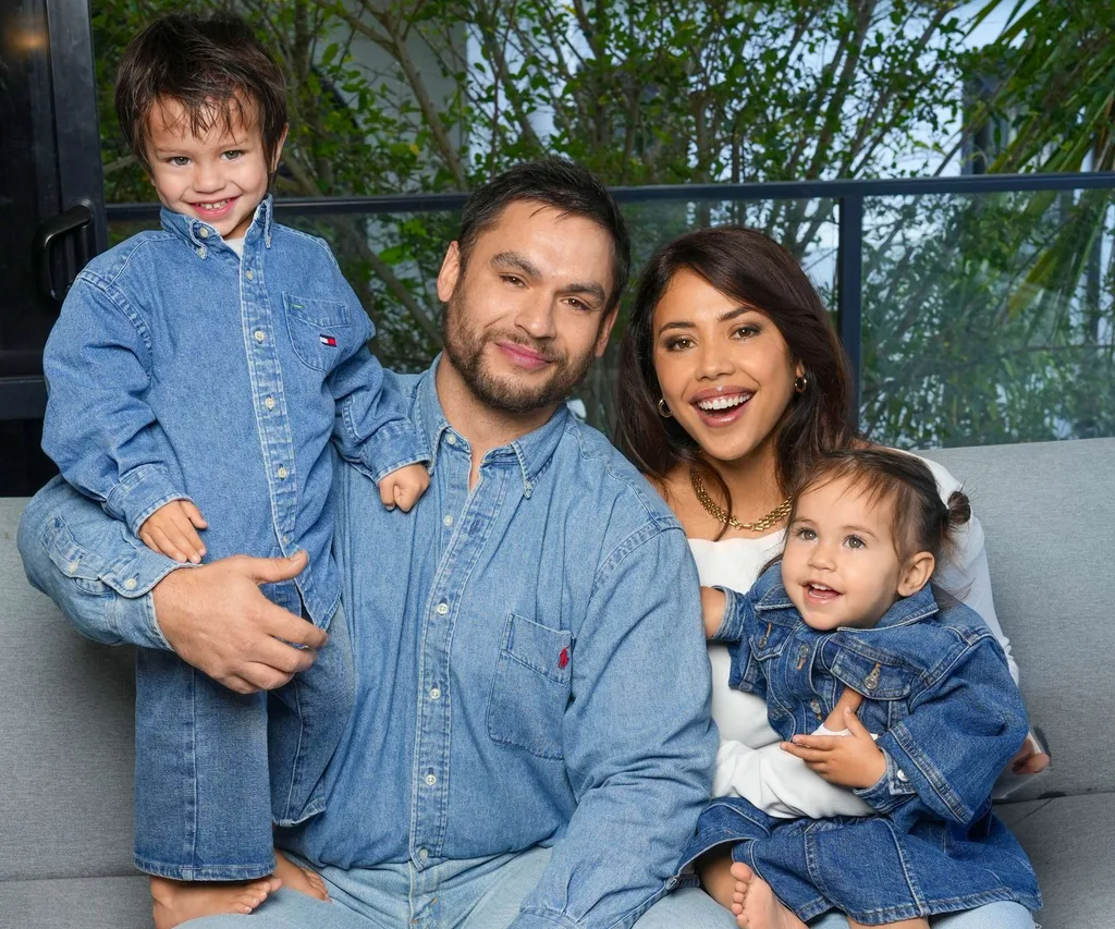 Teone, Ngahuia, Awea and Niau all sitting together on a couch wearing blue denim