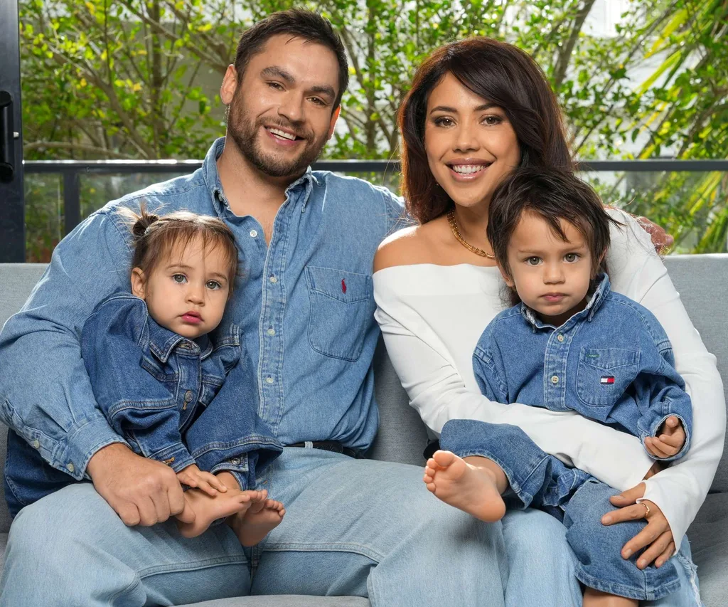 Teone, Ngahuia, Awea and Niau all sitting together on a couch wearing blue denim